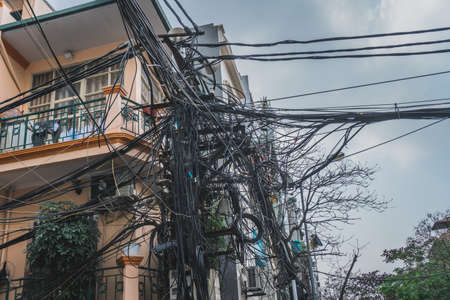 Power lines electric cables in the city streets of Hanoi, Vietnam. Asia