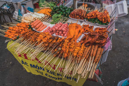 People buy and sell seafood and vegetable on the street food market in Asia. Hoi An, Vietnamの写真素材