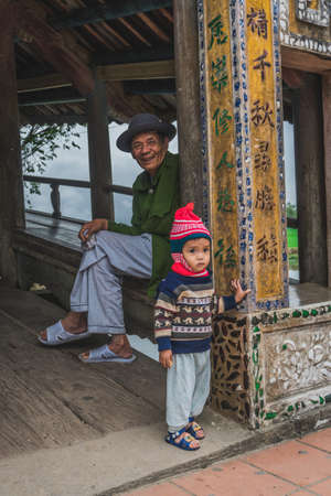 A little Vietnamese girl from the ethnic group poses the foreigner for the camera. Hue, Vietnam - March 8, 2020.のeditorial素材