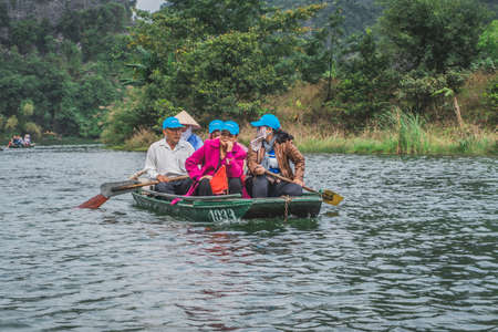 A lot of people are boating on a lake in Vietnam. Ninh Binh, Vietnam - March 7, 2020.のeditorial素材