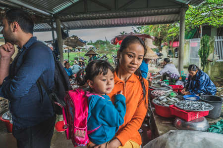 People buy and sell seafood and vegetable on the street food market in Asia. Hoi An, Vietnam - March 13, 2020のeditorial素材