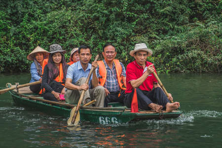 Several people are on a boat in Vietnam. Ninh Binh, Vietnam - March 7, 2020.のeditorial素材