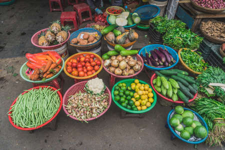 People buy and sell seafood and vegetable on the street food market in Asia. Hoi An, Vietnam - March 13, 2020のeditorial素材