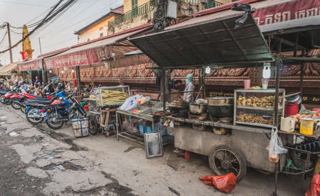 People buy and sell seafood and vegetable on the street food market in Asia. Phnom Penh, Cambodia - FEBRUARY 22, 2020のeditorial素材