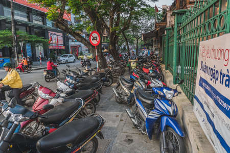 A lot of motorcycles on the tratoire in Vietnam. Hue, Vietnam - March 12, 2020のeditorial素材