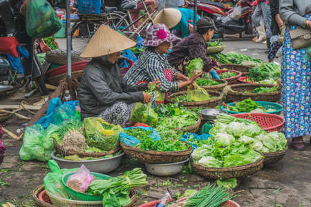 People buy and sell seafood and vegetable on the street food market in Asia. Hoi An, Vietnam - March 13, 2020のeditorial素材