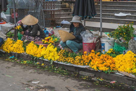 People buy and sell seafood and vegetable on the street food market in Asia. Hoi An, Vietnam - March 13, 2020のeditorial素材