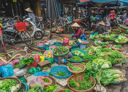 People buy and sell seafood and vegetable on the street food market in Asia. Hoi An, Vietnam - March 13, 2020のeditorial素材