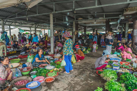 People buy and sell seafood and vegetable on the street food market in Asia. Hoi An, Vietnam - March 13, 2020のeditorial素材
