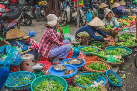 People buy and sell seafood and vegetable on the street food market in Asia. Hoi An, Vietnam - March 13, 2020のeditorial素材