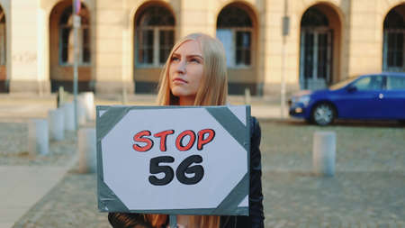 Young woman protesting against 5G internet by walking on the street with steamer.の写真素材
