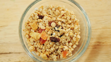 Pouring muesli breakfast mix in bowl. Close up shotの写真素材