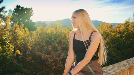 Gorgeous blonde woman enjoying the sun rays in summer. Vacation in the south.