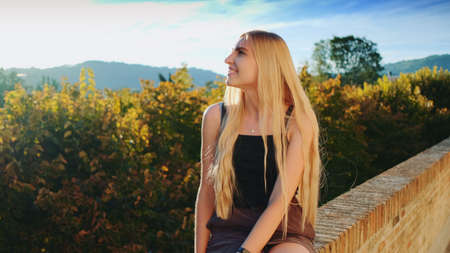 Blonde lady relaxing and smiling. Natural beauty. Having fun on summer time.の写真素材