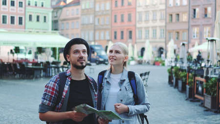 Happy couple of tourists looking on main tourist attractions using map. They are so happy to go sightseeing.の写真素材