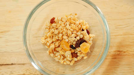 Pouring muesli breakfast mix in bowl. Close up shotの写真素材