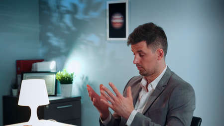 Close-up of elegant man in suit at psychologist therapy session telling about his difficulties and problemsの写真素材