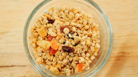 Pouring muesli breakfast mix in bowl. Close up shotの写真素材