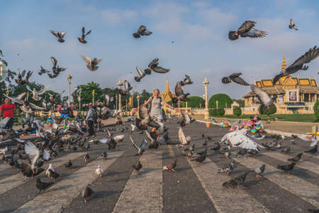 Birds at the Royal Palace park in front of the Royal Palace at the Sisowath Quay at the Tonle Sap River in the city of Phnom Penh of Cambodia. Phnom Penh, Cambodia - FEBRUARY 22, 2020のeditorial素材