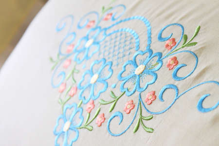 colorful embroidery design on a white pillow