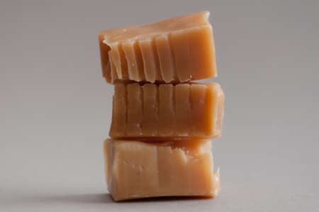 A tower of three toffee sweets on brown の写真素材