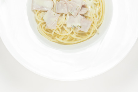 spaghetti with cream sauce top view on a white background の写真素材