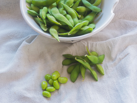 boiled green soybeans on fabric backgroundの写真素材
