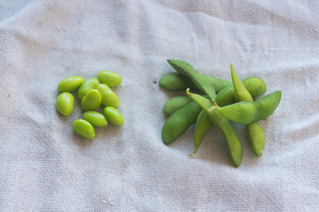 boiled green soybeans on fabric backgroundの写真素材