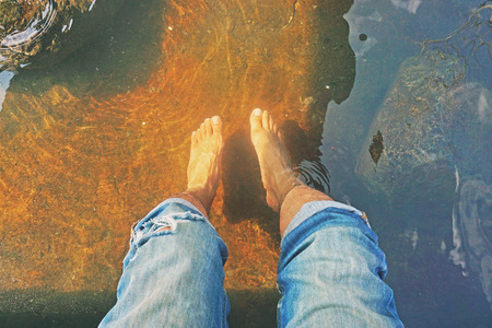 Male Feet Soak in hot springs for health feetの写真素材