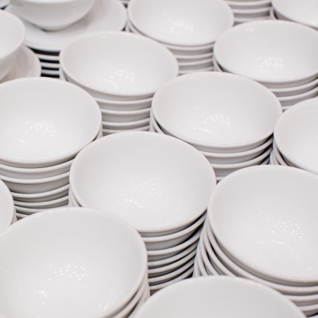 Accurate pile stack of the round ceramic white empty copyspace dish platesの写真素材