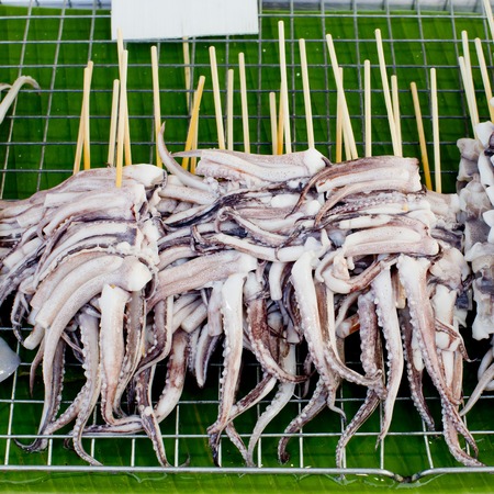 BBQ Squid on a Stick  grilled buttered fresh squid ready to eatの写真素材