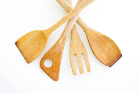 A collection of wooden kitchen utensils isolated on white background