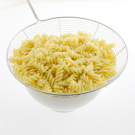 pasta fusilli in plate isolated on white backgroundの写真素材