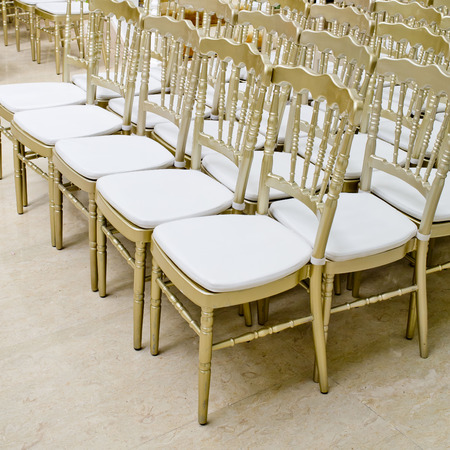 Rows of gold chairs - meeting backgroundの写真素材