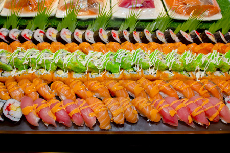 Japanese Cuisine -Buffet catering style Sushi Set in restaurant - salmon Maki Sushi and Nigiri Sushiの写真素材