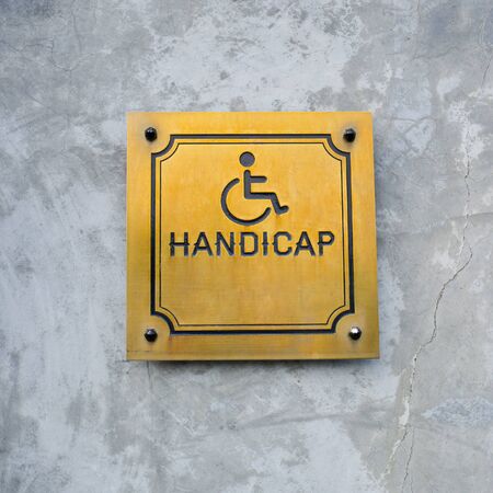 Disabled Handicap Icon and wording Handicap Sign made from gold metal board