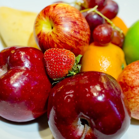 Mix fresh fruits in white dishの写真素材