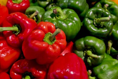 colorful bell peppers with green and red colors, natural backgroundの写真素材