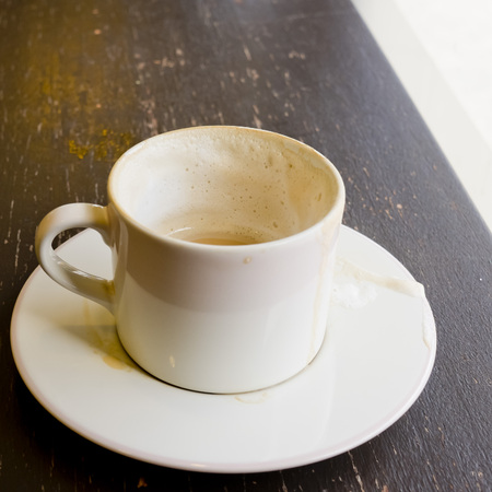 Empty coffee cup on wood table at coffee shop