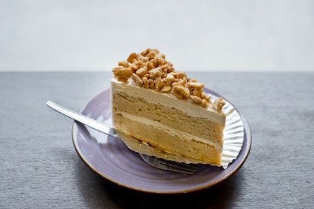Piece of Coffee Cake with slice nuts topping.の写真素材