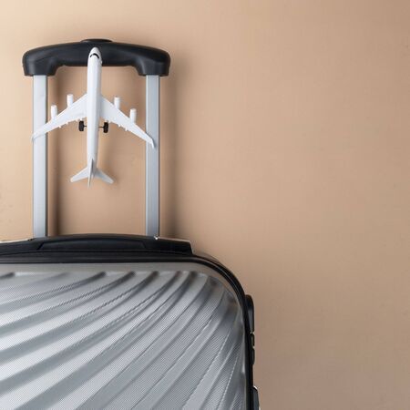Flat lay grey suitcase with mini airplane on pastel background. travel concept - Imageの写真素材
