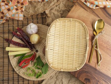 Wood tray with Thai herbs and spoon and fork with free space forの写真素材