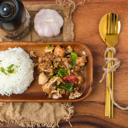 Fried chicken with garlic and pepper with rice. Thai Dish.