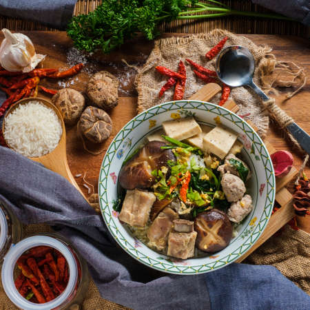Boiled rice with pork, porn bone and thai pork sausage in bowl. Thailand is a popular breakfast.の写真素材