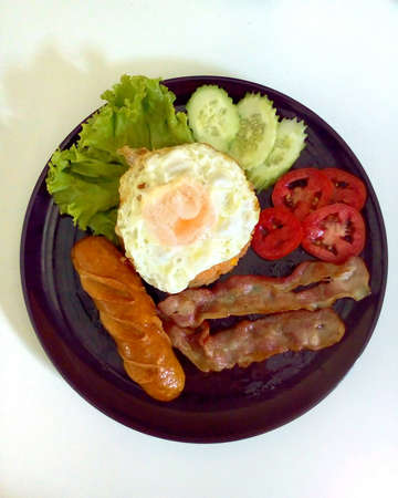 American fried rice with ham and German sausage fried egg on dish.の素材