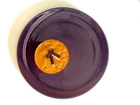 Sweet cake flavored milk tea on dish and have snacks on top.の素材