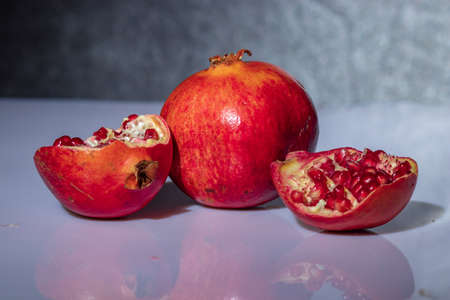 ripe pomegranate with reflection on the glassの写真素材