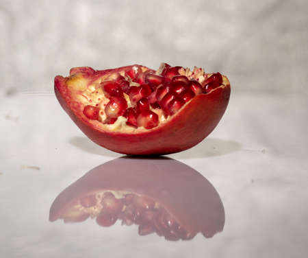 ripe pomegranate with reflection on the glassの写真素材