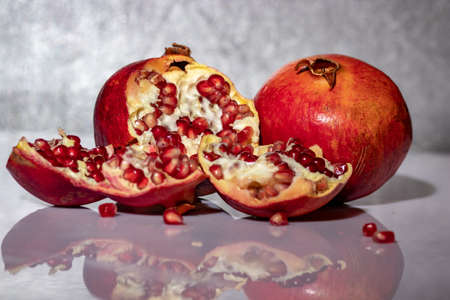 ripe pomegranate with reflection on the glassの写真素材