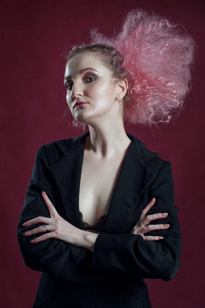 Fashion portrait of woman posing on pink background.の写真素材